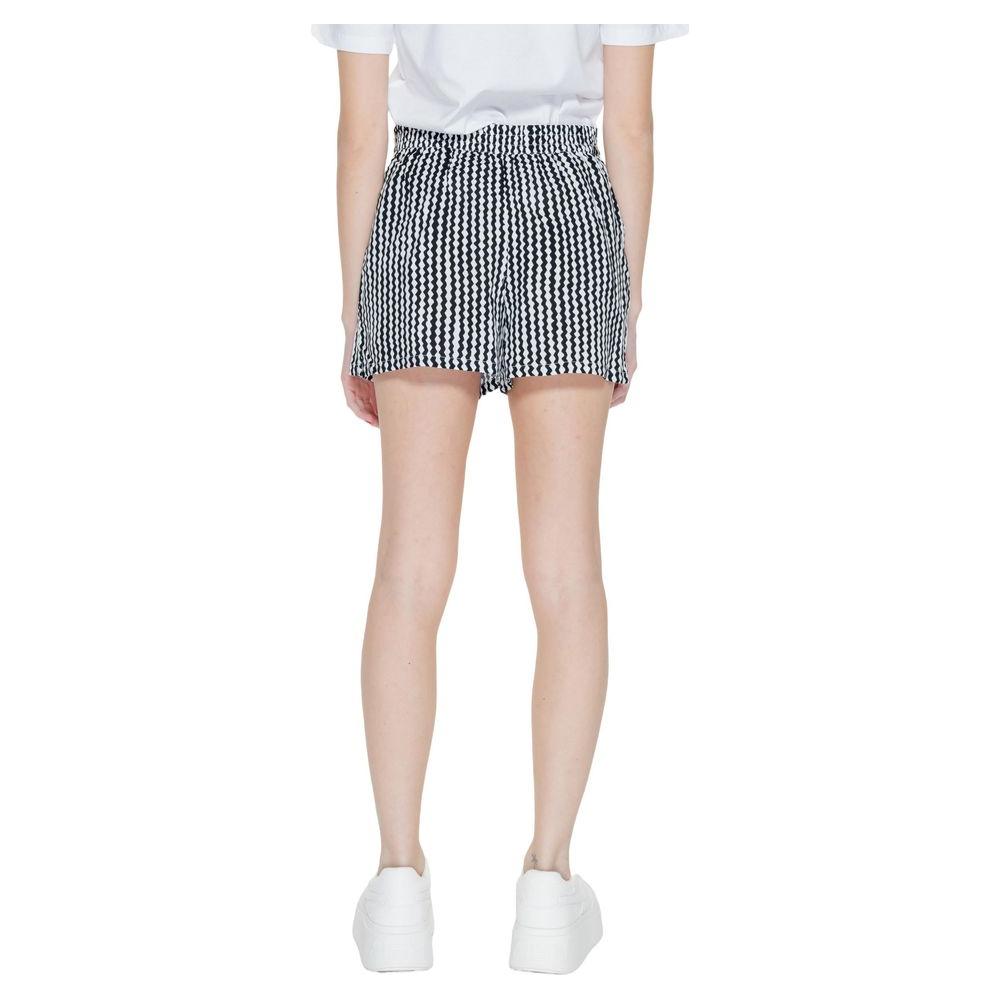 Back view of black viscose women's shorts, part of the spring/summer collection, worn on a model with a white top and sneakers.