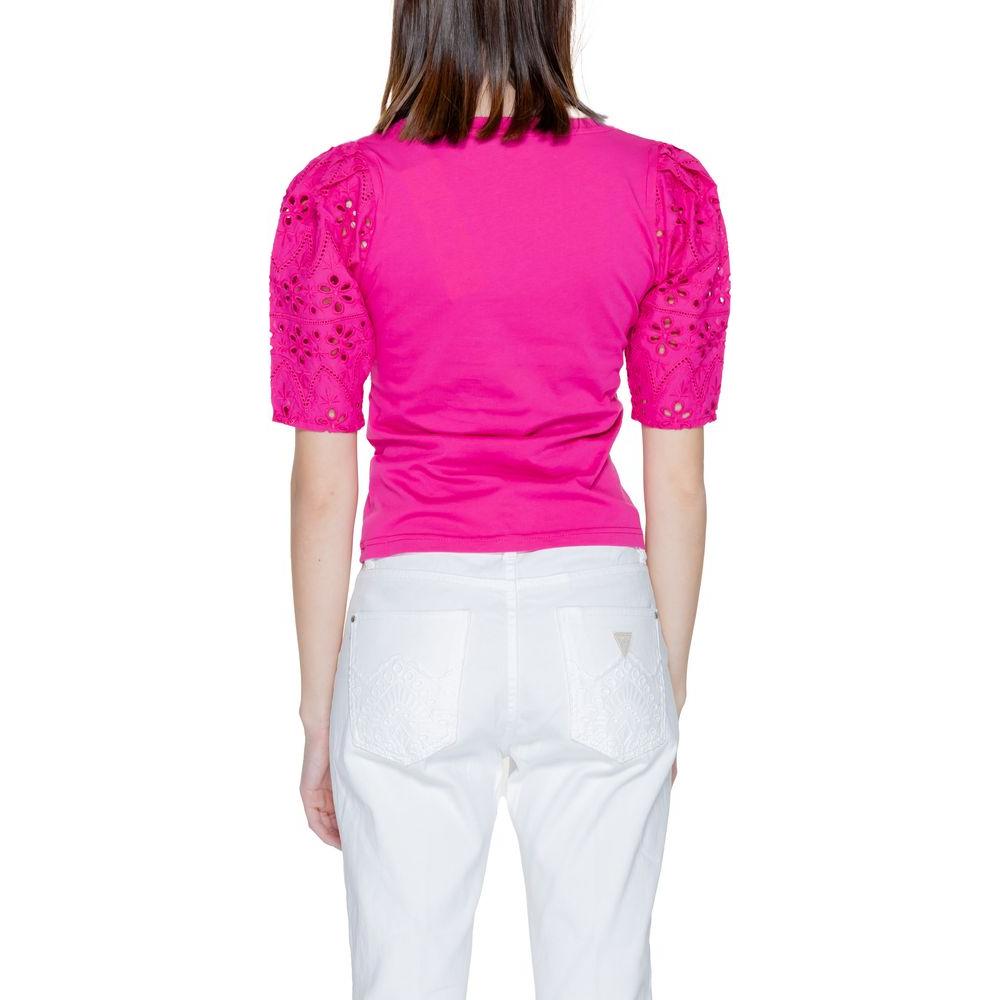 Back view of a woman wearing a Morgan De Toi pink cotton T-shirt from the Spring/Summer collection, featuring short sleeves and intricate details.