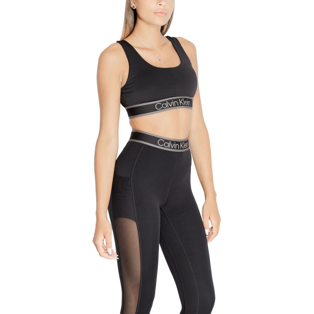 Woman wearing Calvin Klein Sport black polyester sports bra with branding