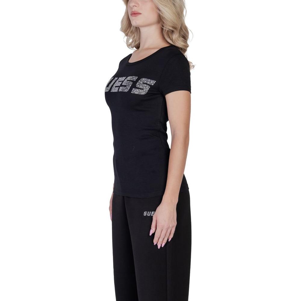 Woman wearing Guess Active black short-sleeve cotton top with embossed logo, displaying a stylish and fitted silhouette.