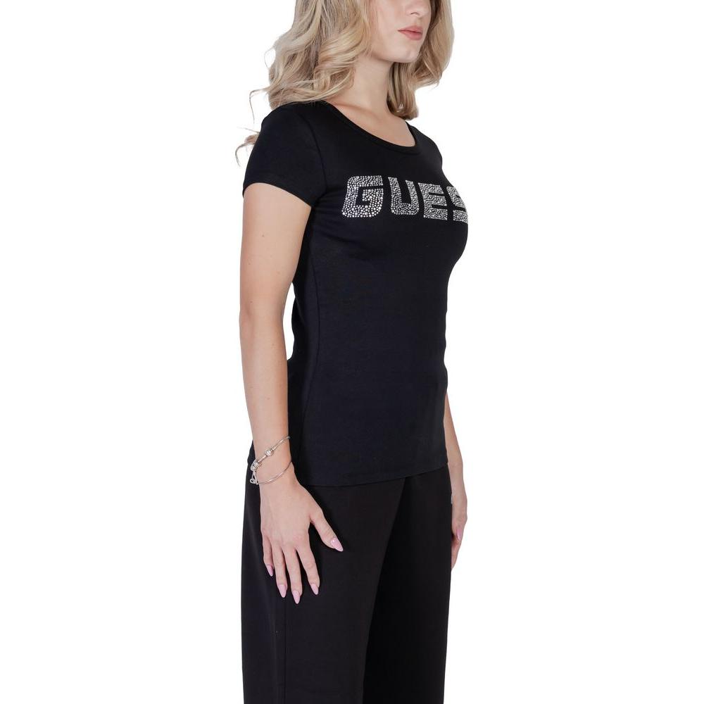 Woman wearing Guess Active Black Cotton T-Shirt with embossed logo, showcasing a fitted design and comfort for everyday style.