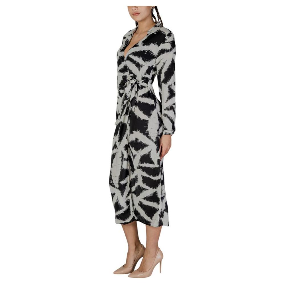 Jacqueline De Yong black recycled polyester dress, long fall/winter style with abstract pattern, sustainable women's fashion, side view.