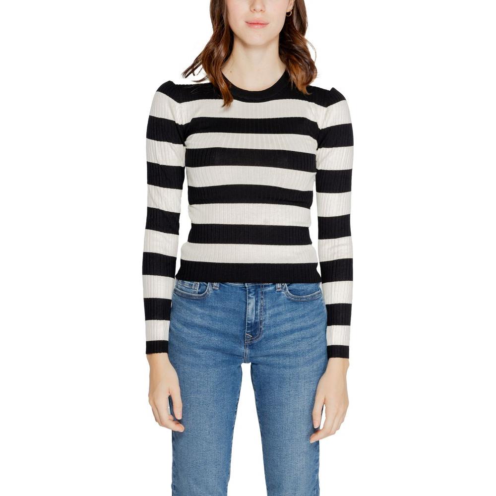 Woman wearing a black and white striped long-sleeve knit top with blue jeans, featuring Jacqueline De Yong Fall/Winter collection style.