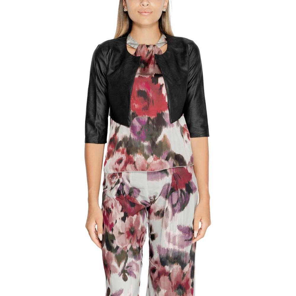 Rinascimento black polyethylene women's shoulder cover for fall/winter, worn over floral outfit, 100% polyurethane.