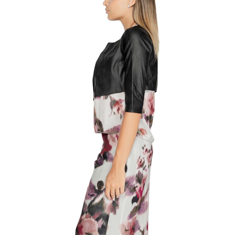 Side view of a woman wearing a black polyethylene shoulder cover top with floral design, part of Rinascimento's fall/winter collection.