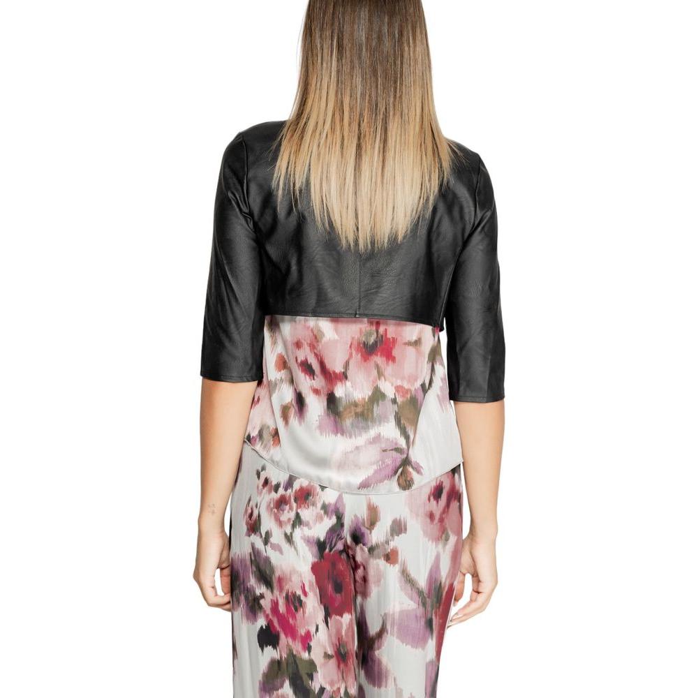 Rear view of woman wearing Rinascimento black polyethylene top, floral dress, Fall/Winter collection, 100% polyurethane.