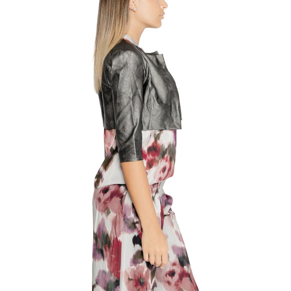 Side view of a model wearing Rinascimento gray polyethylene shoulder cover and floral dress, Fall/Winter collection.