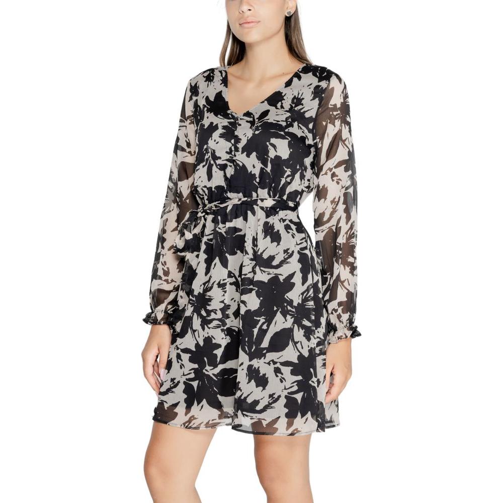 Model wearing Jacqueline De Yong black dress made from recycled polyester, featuring floral design for fall/winter collection.