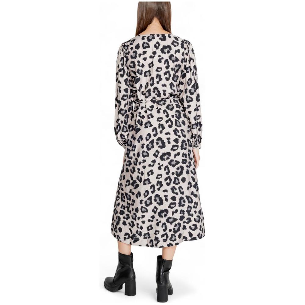 Back view of Jacqueline De Yong gray viscose leopard print dress, fall/winter collection, shown with black ankle boots.
