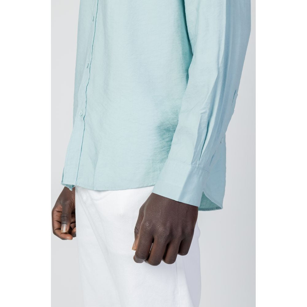 Side view of a man wearing Antony Morato green viscose long-sleeve shirt paired with white pants, showcasing regular fit design.