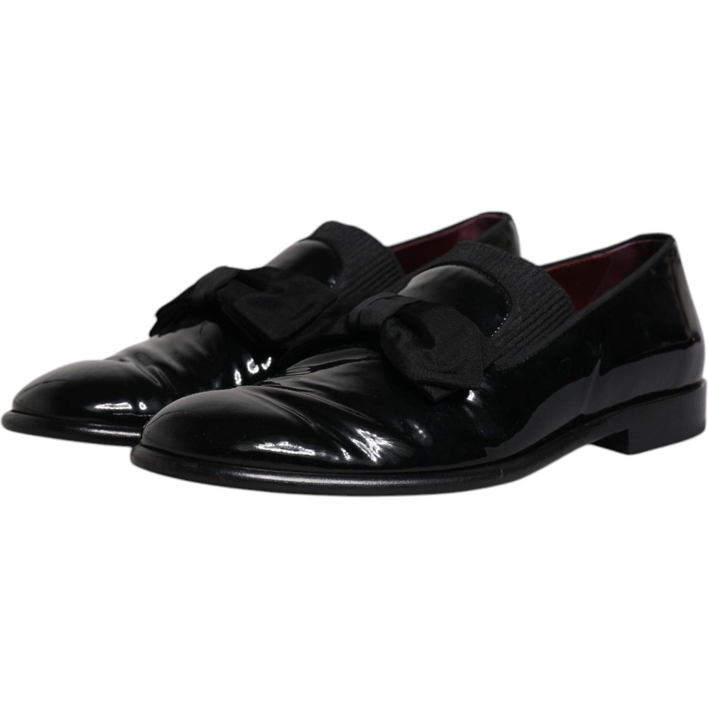 Dolce & Gabbana black leather loafers for men, formal dress shoes, preowned with tags, made in Italy, elegant design with bow details.