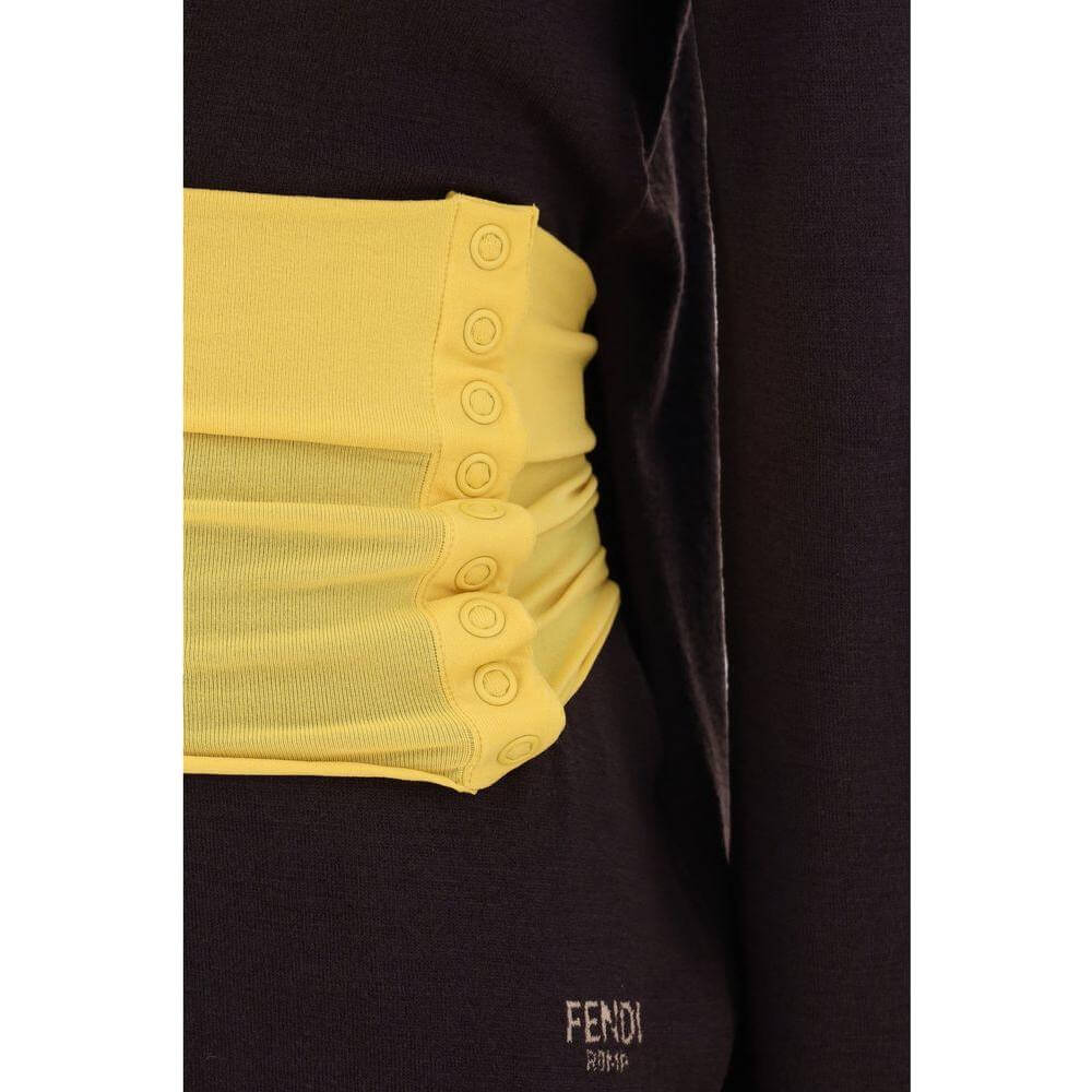 Close-up of Fendi turtleneck sweater featuring yellow ribbed built-in waistband with snaps, showcasing detailed craftsmanship.