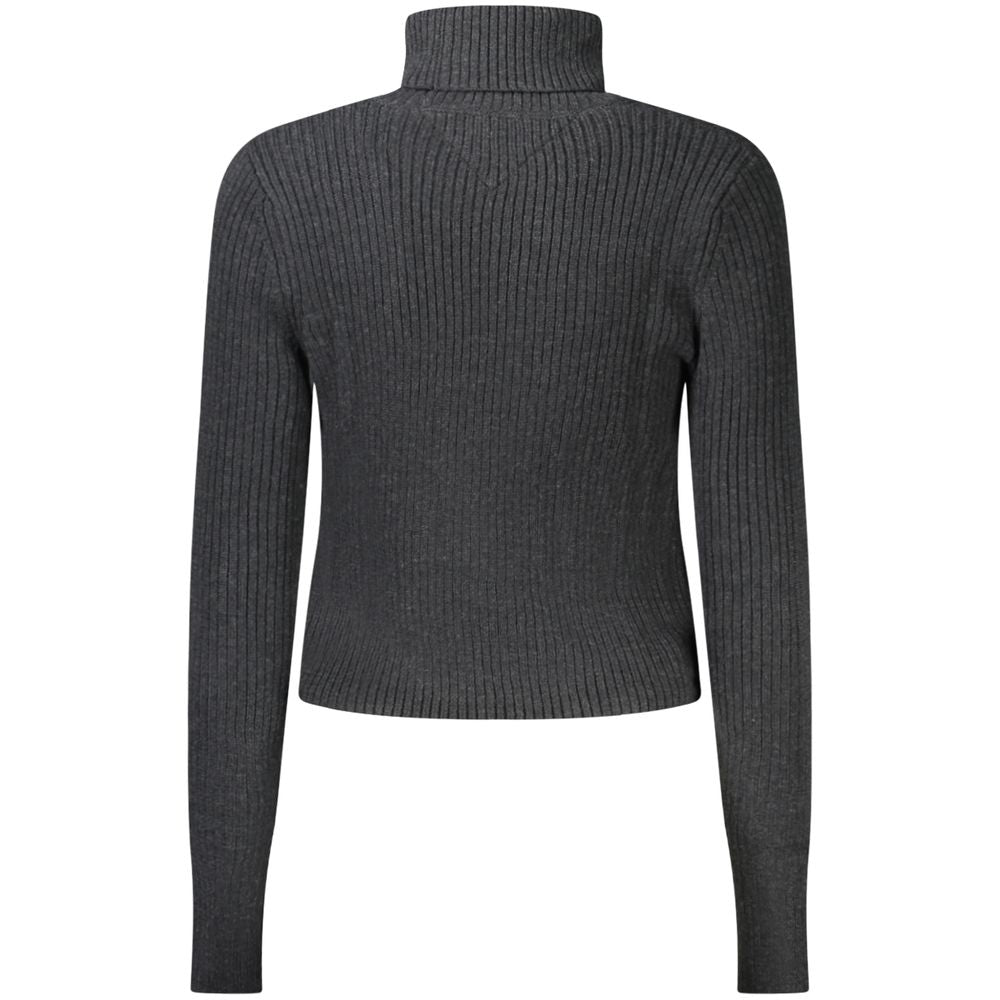 Back view of Tommy Hilfiger black polyester women's turtleneck sweater with embroidered logo, showcasing elegant knit texture.