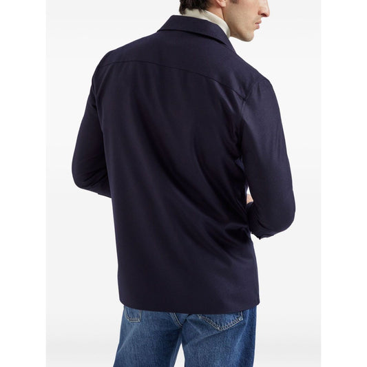 Back view of Brunello Cucinelli Shirts Blue with button fastening and chest flap pockets, showcasing long sleeves and buttoned cuffs in wool.