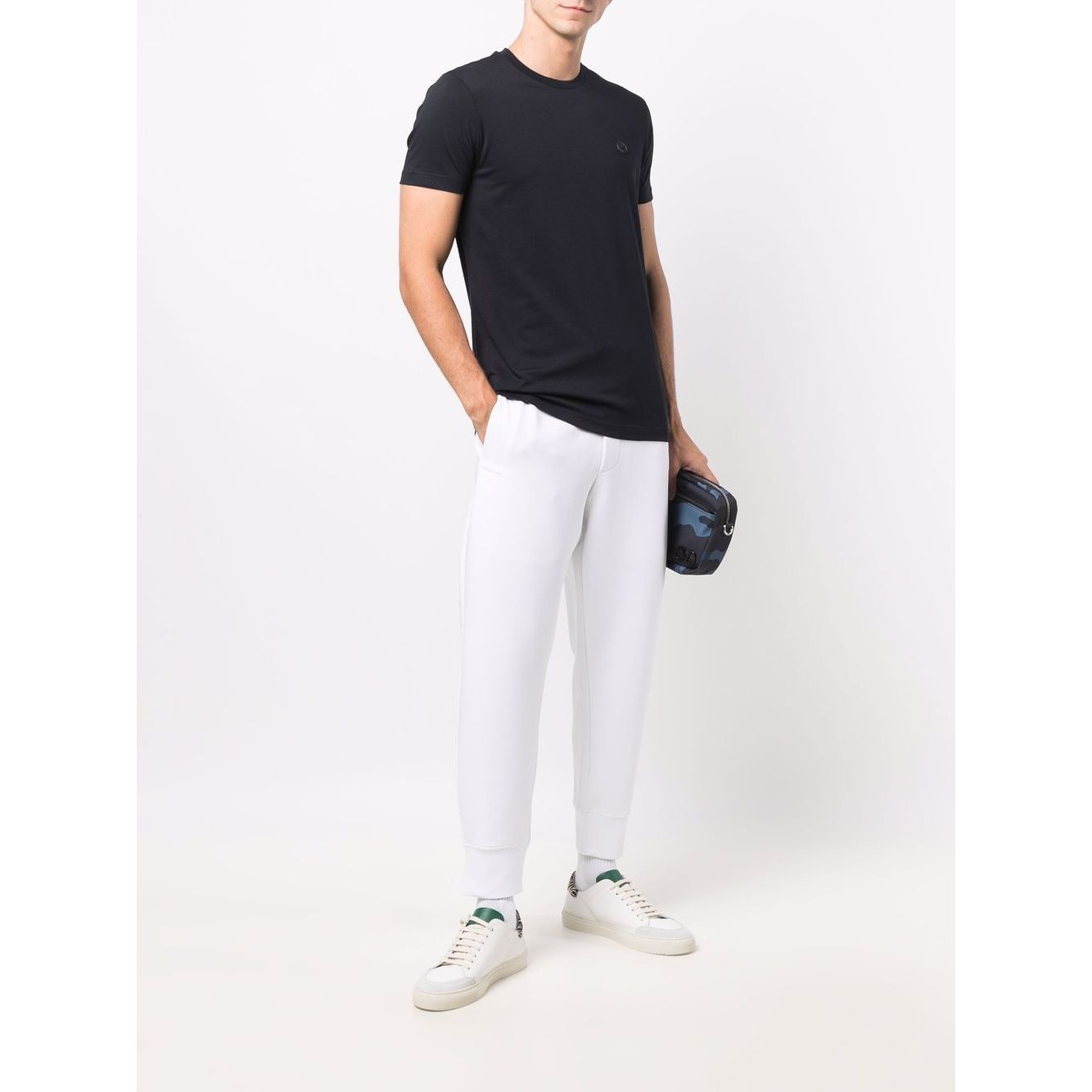 Man wearing Emporio Armani T-shirts and Polos Blue, navy blue cotton short sleeves, round neck, with logo patch at the chest.