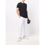 Man wearing Emporio Armani T-shirts and Polos Blue, navy blue cotton short sleeves, round neck, with logo patch at the chest.