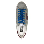 Golden Goose Super-Star sneakers with desert sage green suede, blue laces, padded ankle, removable insole, and 2 cm heel height.