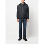 Emporio Armani Coats Blue, navy blue nylon blouson jacket with monogram jacquard, silver-tone hardware, drawstring hood, and zip fastening.