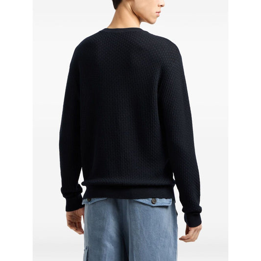 Man wearing Emporio Armani Sweaters Blue, dark waffle knit crew neck with long sleeves and straight hem, wool material from back view.