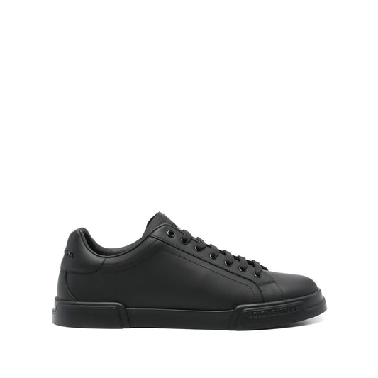 Dolce & Gabbana Sneakers Black featuring front lace-up, round toe, flat rubber sole, Portofino leather design.