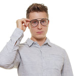 Man wearing Police Gray Men Glasses Frame in aviator style with grey metal and plastic material, showcasing full-rim design.