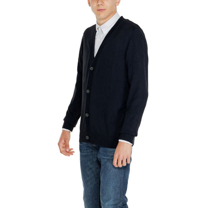 Man wearing Jack Jones Black Cotton Cardigan with button-down front and V-neckline, paired with jeans.