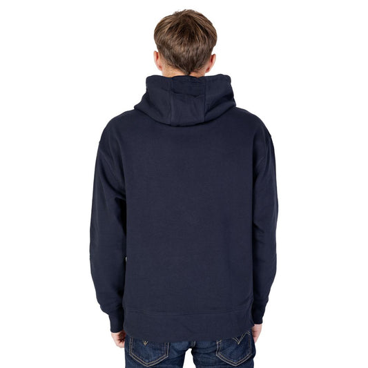 Back view of a men's fall/winter Tommy Hilfiger blue cotton hoodie made from recycled materials.