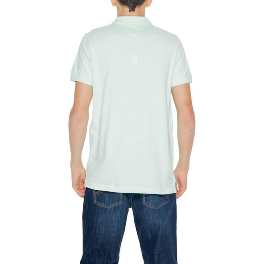 Back view of a man wearing a Tommy Hilfiger green cotton polo shirt and blue jeans, perfect for spring/summer fashion.