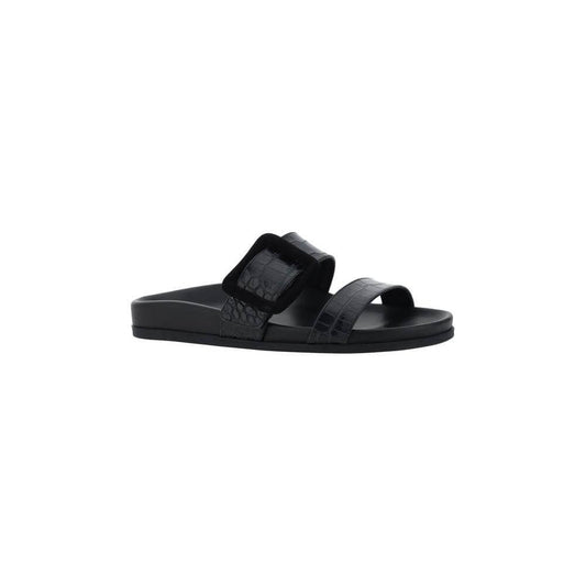 Black Manolo Blahnik Mayfu Sandals with double strap, croc-effect leather, and embossed buckle, featuring a flat sole and round toe.