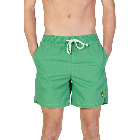 Lyle & Scott men's green nylon swimwear for fall/winter collection, featuring adjustable drawstring and logo patch on left leg.
