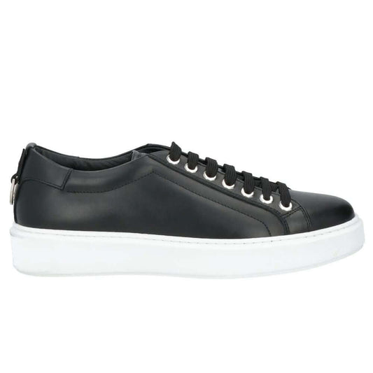 Les Hommes black calfskin men’s sneakers with white sole, silver logo on tongue, and decorative metal ring at heel.