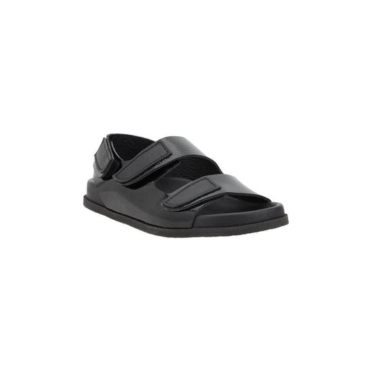 Pedro García Dinka Sandals with black leather and Velcro closure, featuring a round toe and flat sole for comfort and style.