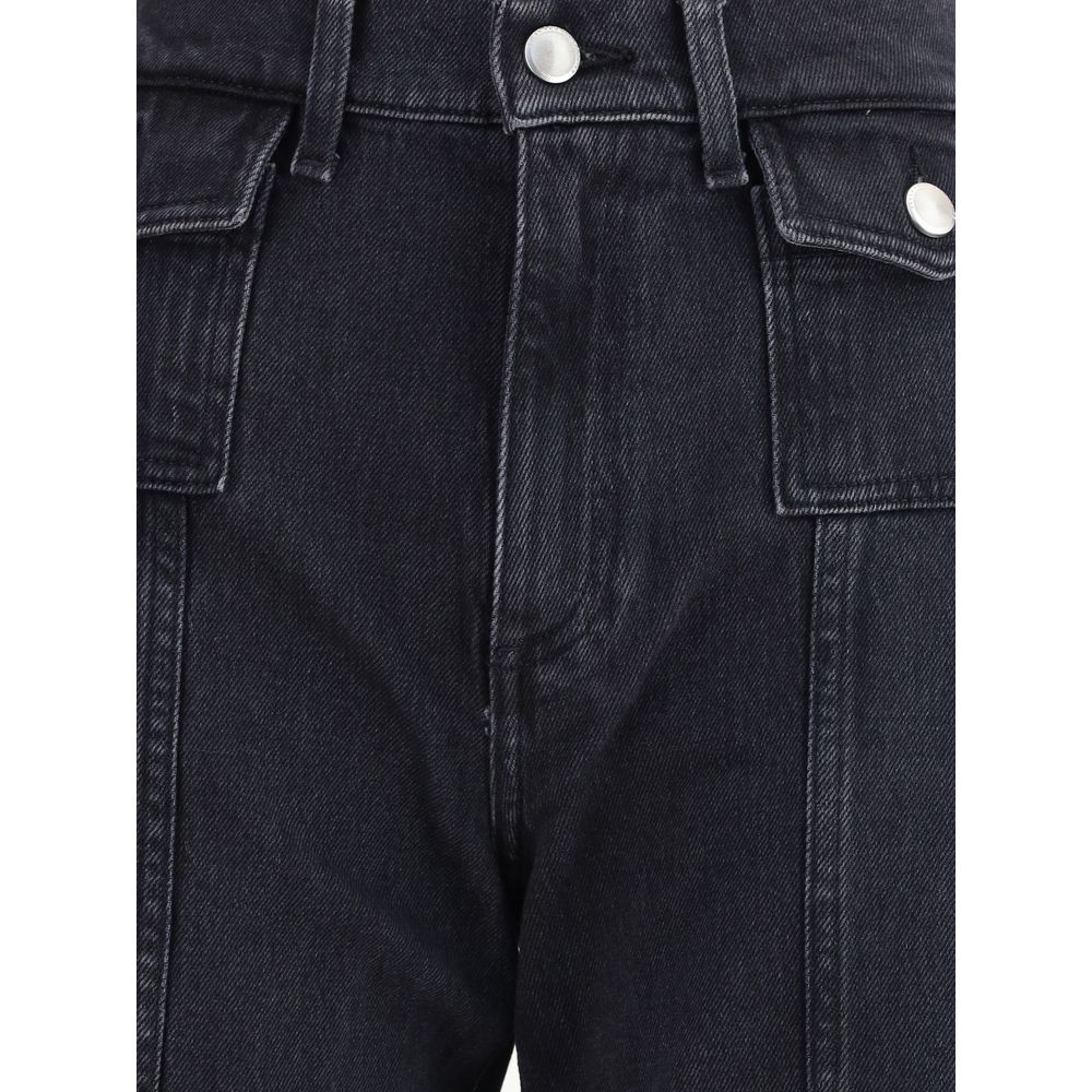 Close-up of 7FOR Black Cotton Jeans Denim showing high-waisted design and gold-trimmed flap pockets with front seam detail.