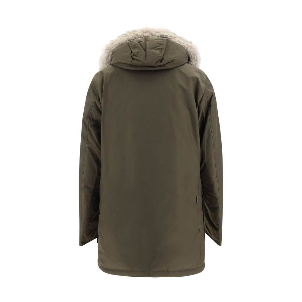 Back view of Woolrich Green Cotton Parka with fur-trimmed hood and padded design, featuring an oversize fit.