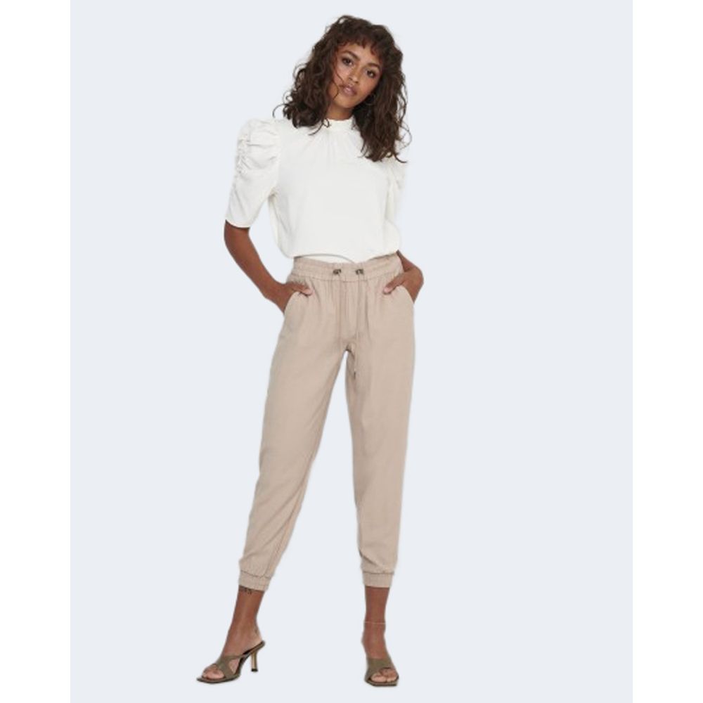 Woman wearing Only Beige Viscose Casual Pants with elastic cuffs and a white top, demonstrating a stylish and comfortable outfit.