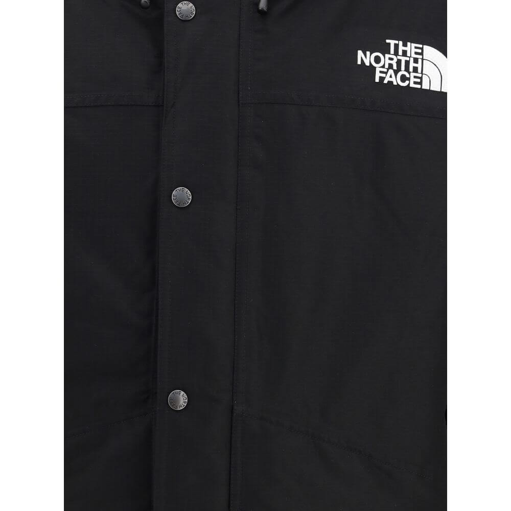 Close-up of The North Face Black Polyester Coat with logo and buttons.