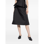 Model wearing Alexander McQueen Skirts Black, black satin finish A-line silk skirt, showcasing elegant fashion style.