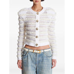 Woman wearing Balmain Long-sleeved tweed-effect knit cardigan with gold buttons and ribbed trim, styled with blue jeans.