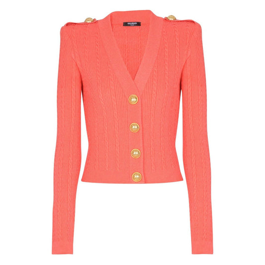 Balmain Long-sleeved twisted knit cardigan in coral pink with button fastening and logo-embossed buttons, featuring epaulettes and V-neck.