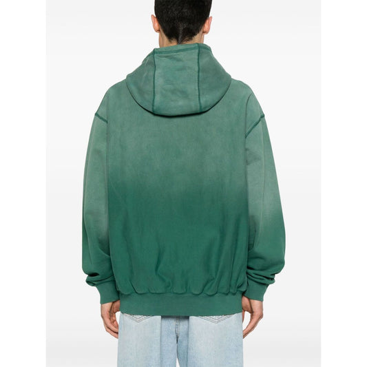 Back view of model wearing Billionaire Sweaters Green oversized hoodie with ribbed cuffs and hem.