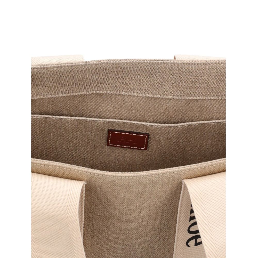 Interior view of Chloé Chloe Woody Medium Tote Bag showing the linen composition and internal flat pocket.
