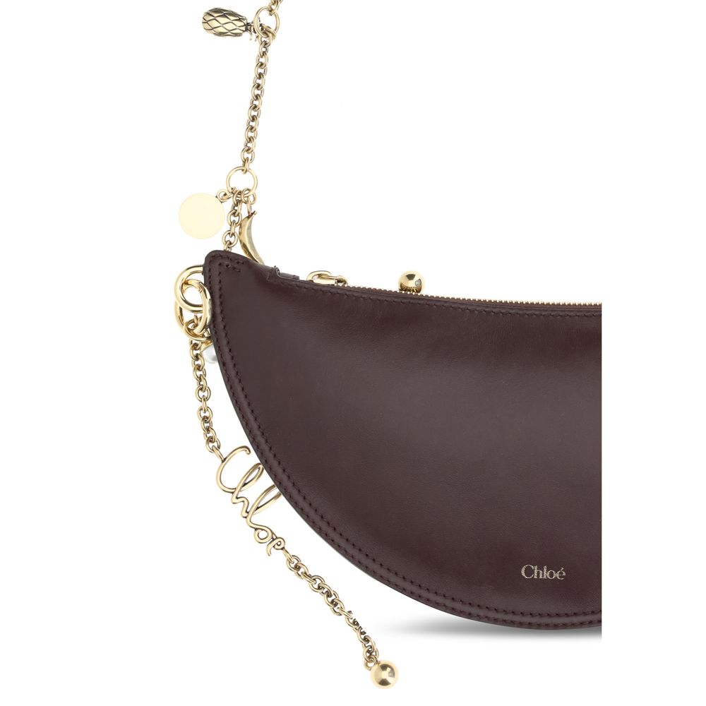 Close-up of Chloé Icons Shoulder Bag in lambskin nappa leather with gold chain and charms.