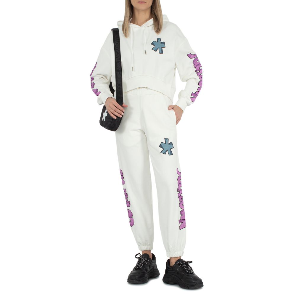Alt Tag: Comme Des Fuckdown White Cotton Jeans & Pant with logo embroidery, side pockets, drawstring, worn by a person with a black bag.