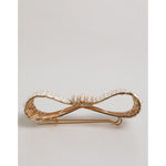 Dolce & Gabbana Gold Tone Brass Bow Crystal FauxPearl Embellished Brooch with white pearls and crystals on display.