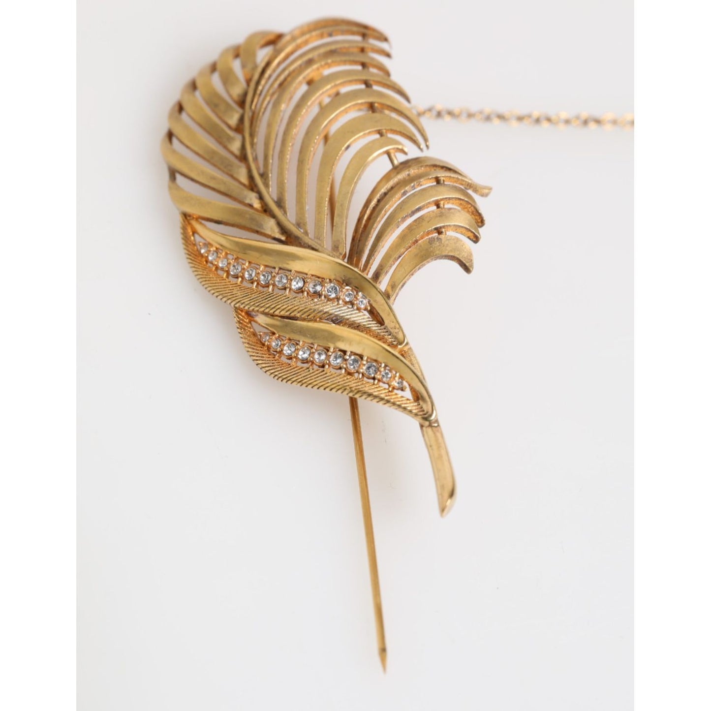 Dolce & Gabbana Gold Tone Leaf 925 Sterling Silver Crystal Chain Brooch with elegant leaf design and sparkling crystals.