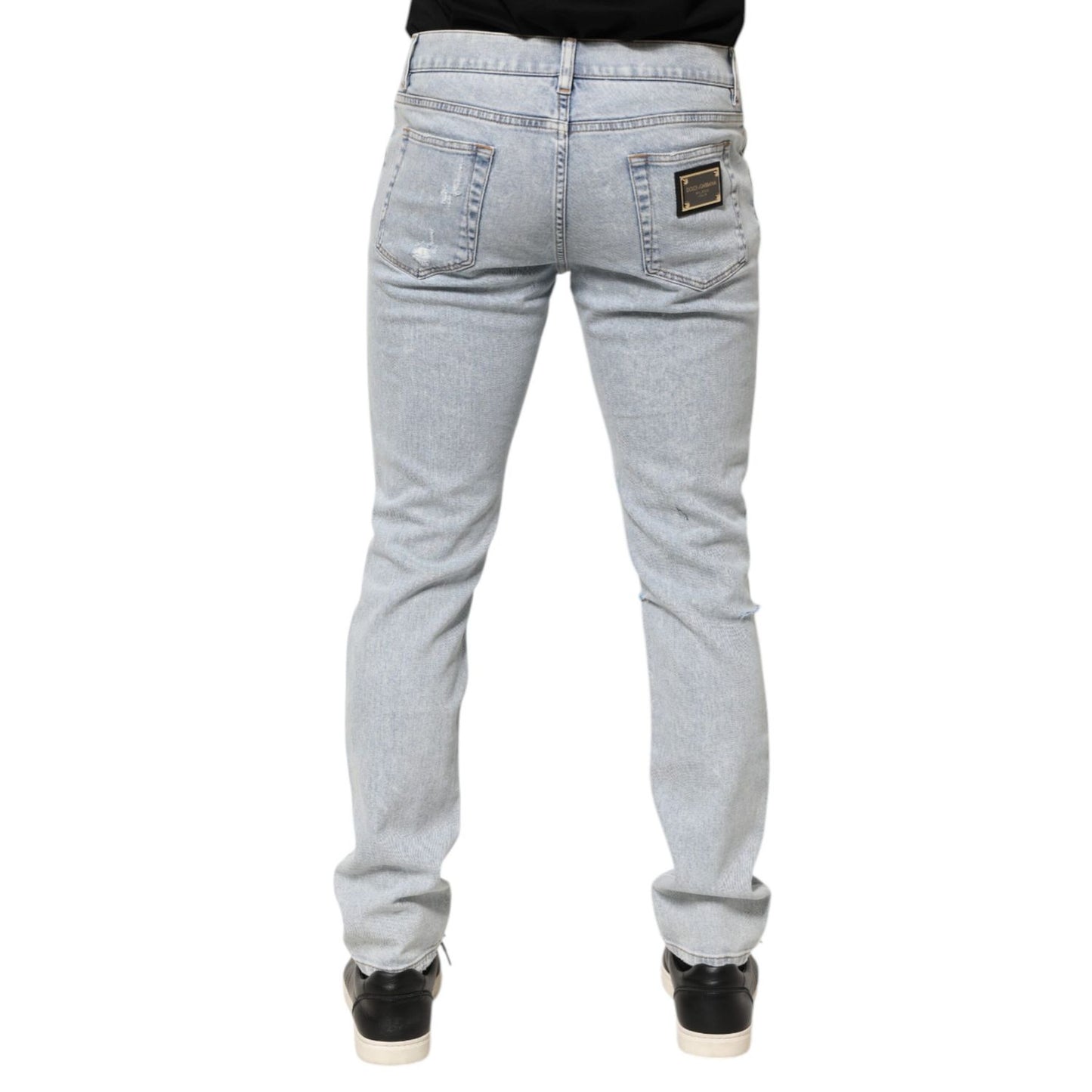Back view of Dolce & Gabbana Light Blue Distressed Slim Fit Ripped Denim Jeans showcasing design details.