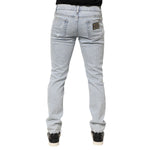 Back view of Dolce & Gabbana Light Blue Distressed Slim Fit Ripped Denim Jeans showcasing design details.
