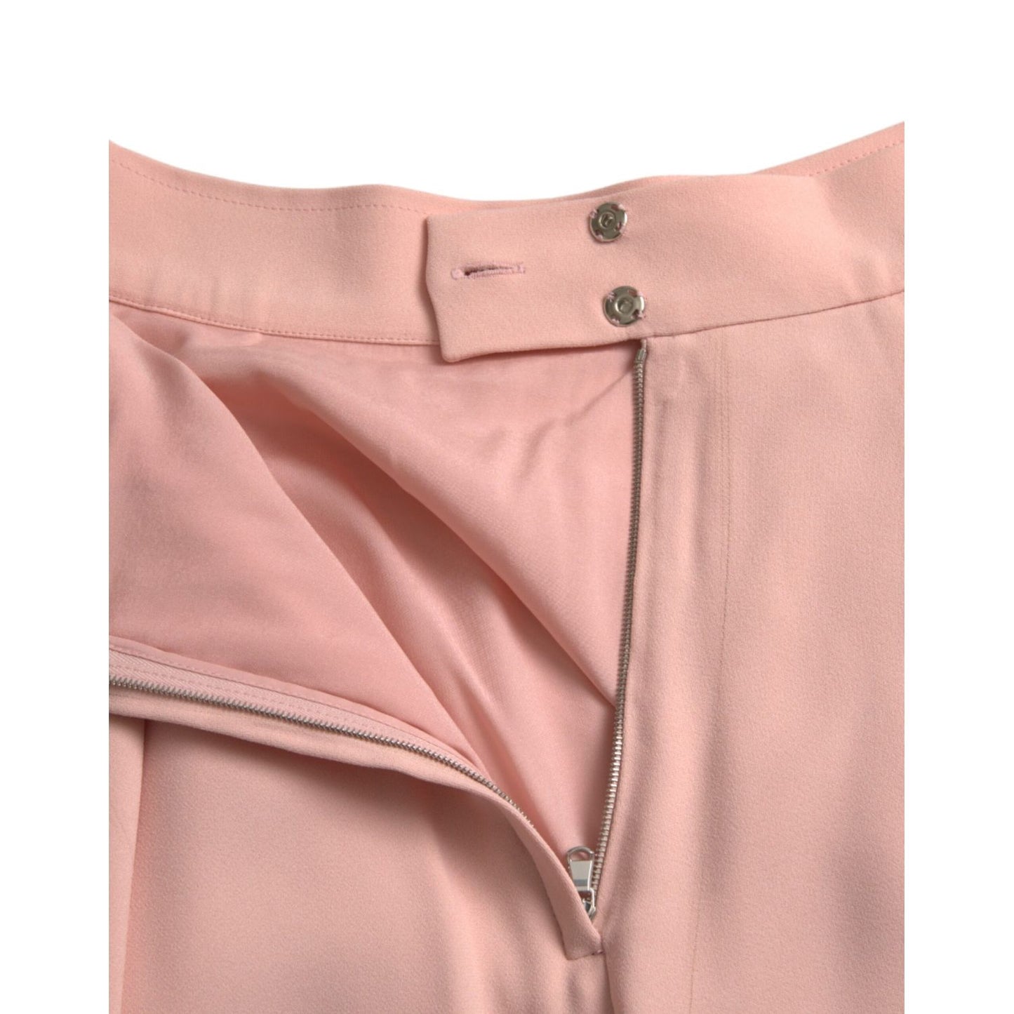 Close-up of Dolce & Gabbana Light Powder Rose Viscose Pleated Skirt featuring side zip and snap closure details.