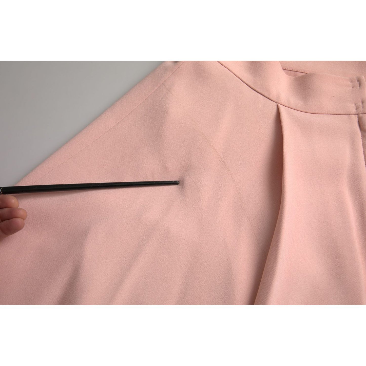Close-up of Dolce & Gabbana Light Powder Rose Viscose Pleated Skirt showing the fabric detail and pleats.
