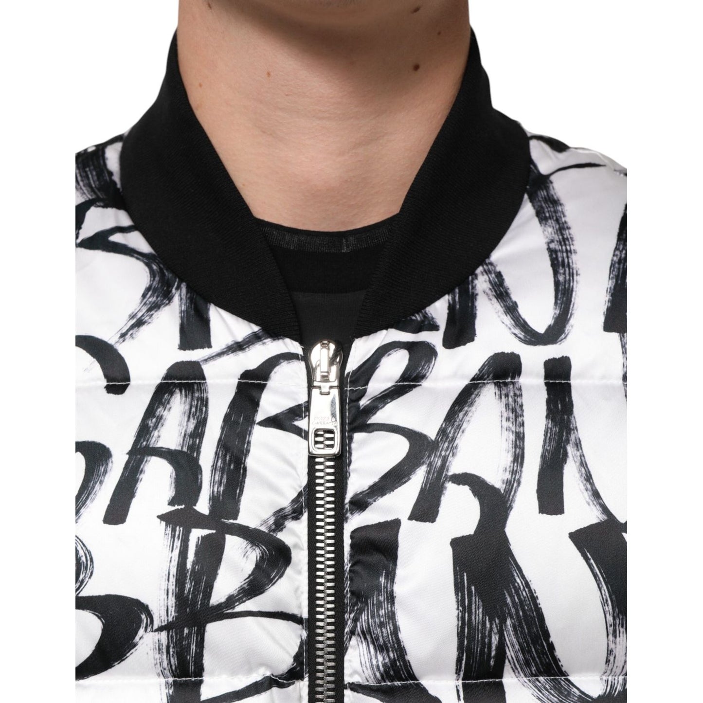 Close-up of the Dolce & Gabbana White Black Graffiti Logo Puffer Bomber Jacket showcasing the graffiti-style print.